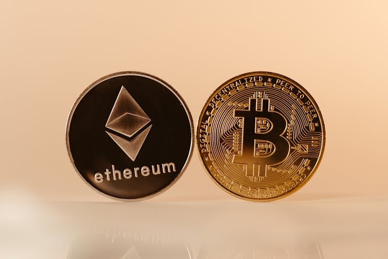 Close-up of Ethereum and Bitcoin coins representing modern digital currency and blockchain technology.