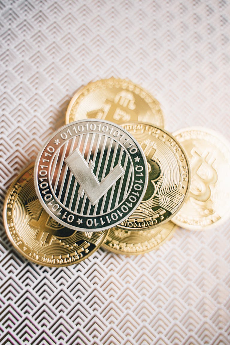 Close-up of Litecoin and Bitcoin coins on a textured surface, representing digital currency themes.