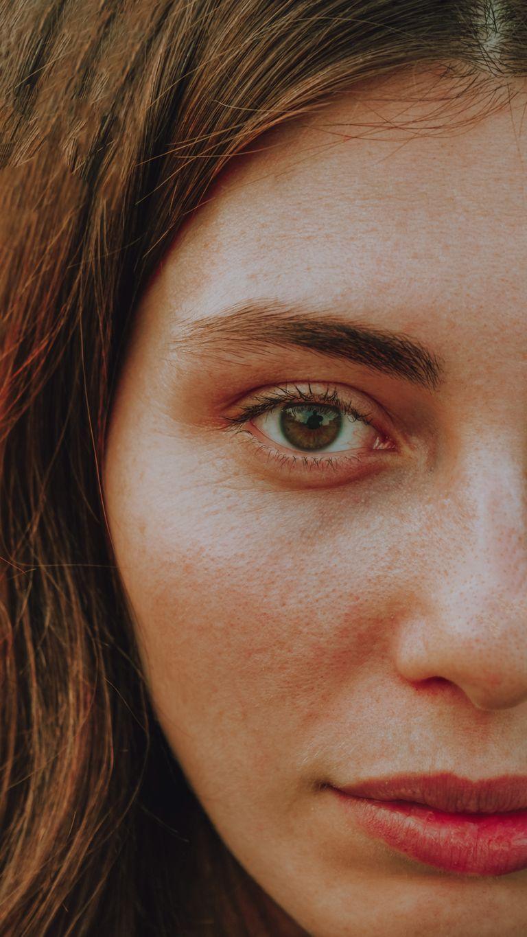 Detailed close-up of a woman's eye and face, highlighting natural beauty.